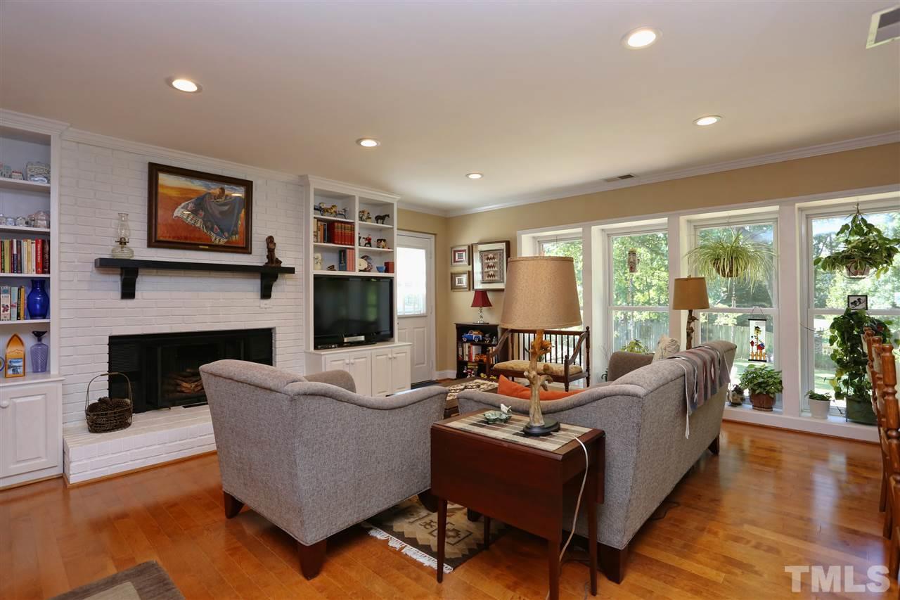 1809 Albacore Lane Raleigh, NC 27612 - Photo 5 of 25 a living room with fireplace furniture and a flat screen tv