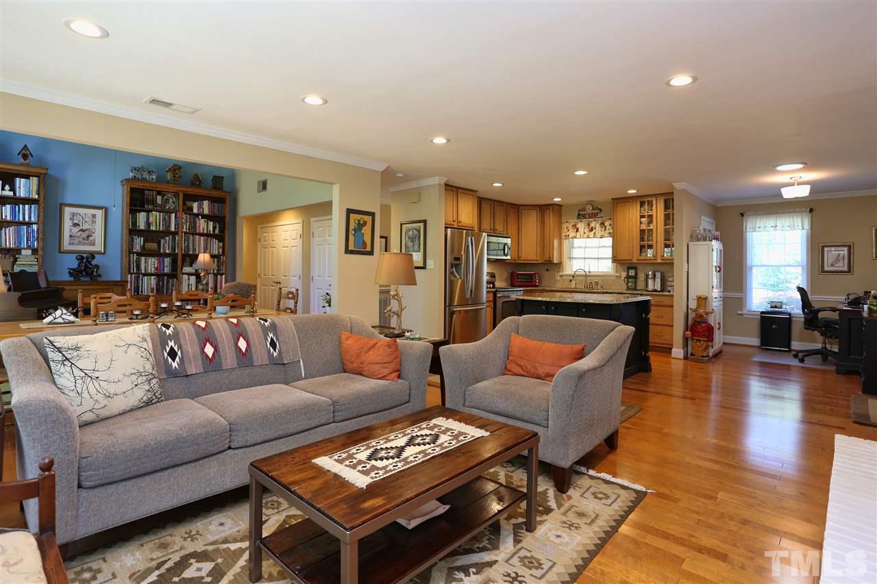 1809 Albacore Lane Raleigh, NC 27612 - Photo 7 of 25 a living room with furniture and a wooden floor