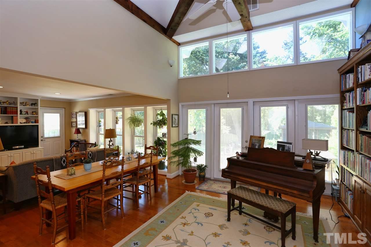 1809 Albacore Lane Raleigh, NC 27612 - Photo 9 of 25 a living room with furniture a rug and a large window