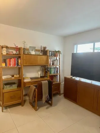 a bed room with furniture and flat screen tv