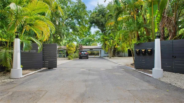 a view of a car parked in back of the house