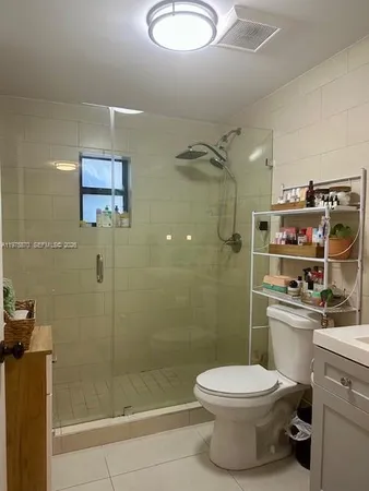 a bathroom with a toilet a sink and shower