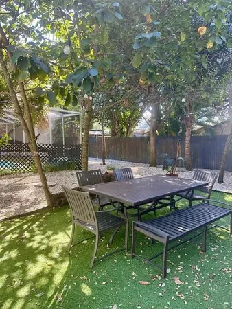 a view of a backyard with table and chairs