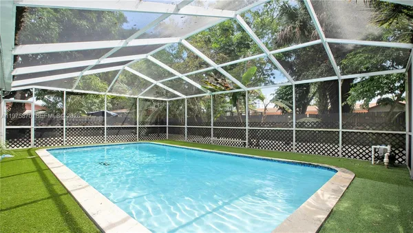 a view of a room with wooden floor and windows
