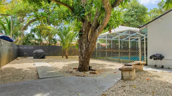 a backyard of a house with table and chairs
