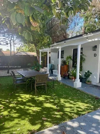 a view of a house with a yard porch and sitting area