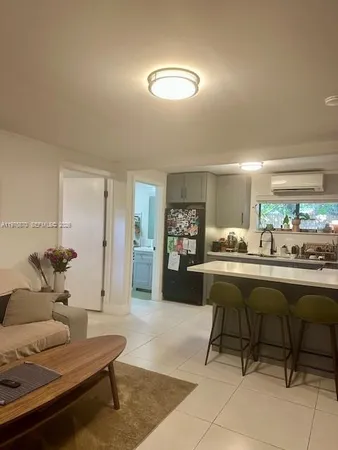 a living room with furniture a rug and a large window