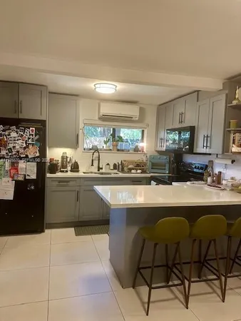 a kitchen with stainless steel appliances a refrigerator sink and cabinets