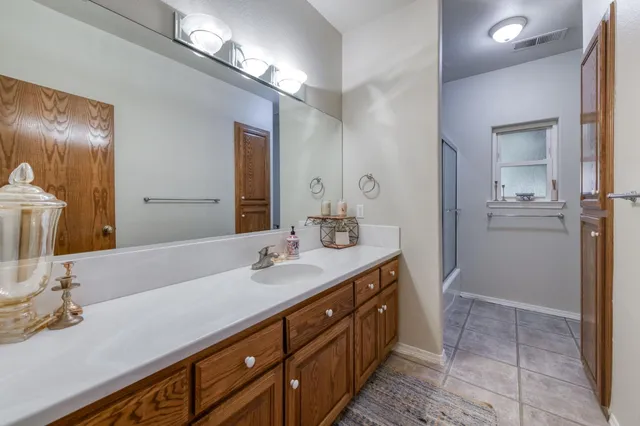 a bathroom with a shower and a sink