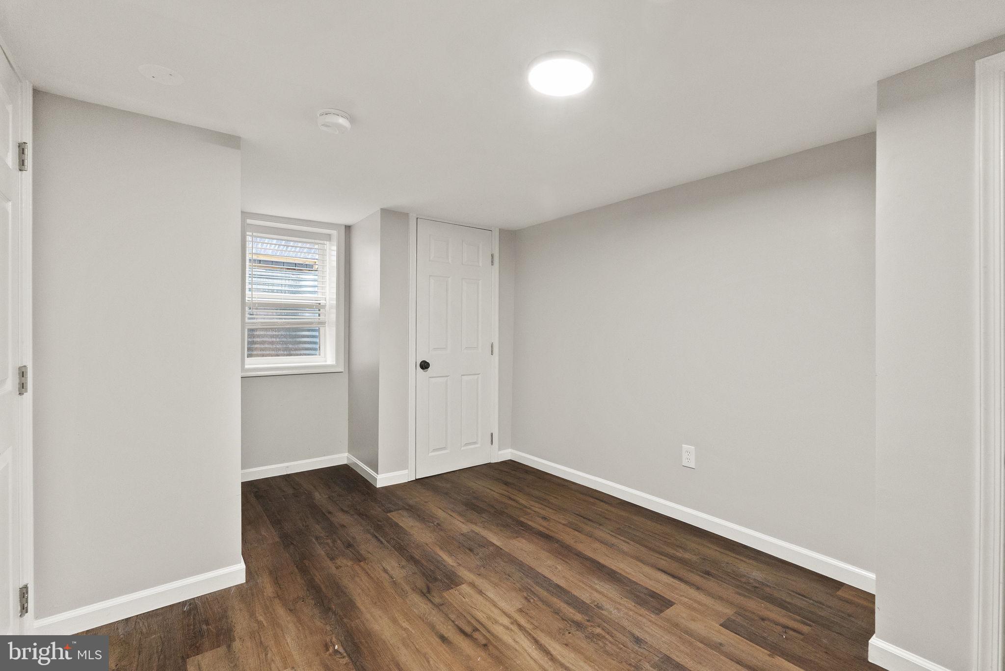 6314 7th Street Northwest Washington, DC 20011 - Photo 7 of 19 an empty room with wooden floor and windows