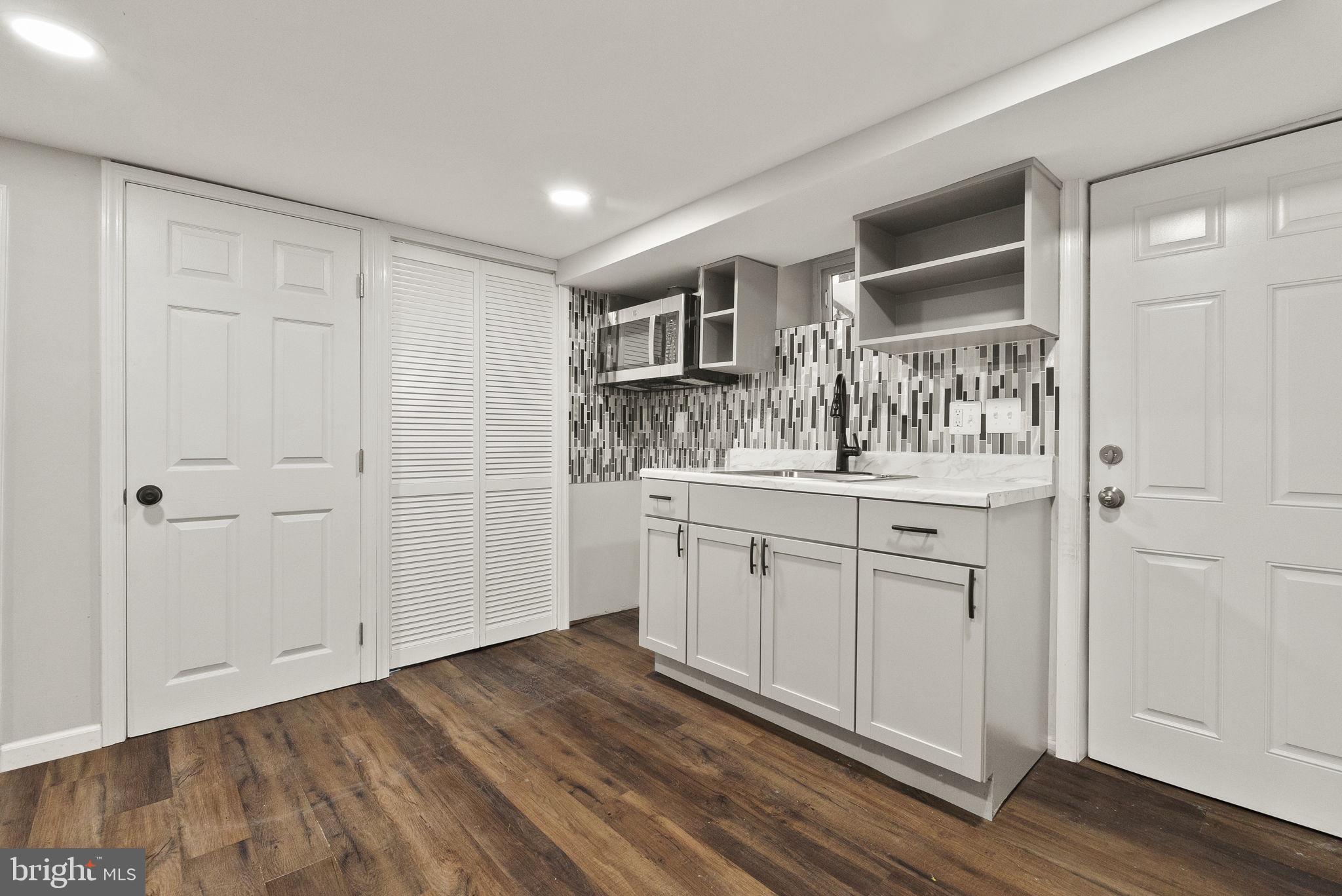 6314 7th Street Northwest Washington, DC 20011 - Photo 9 of 19 a kitchen with white cabinets and sink