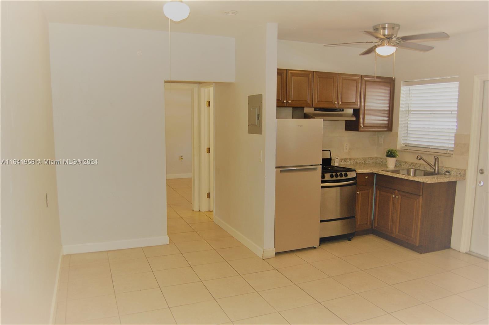 2481 Southwest 11th Street, Unit 2481 Miami, FL 33135 - Photo 2 of 9 a kitchen with stainless steel appliances a refrigerator stove and sink