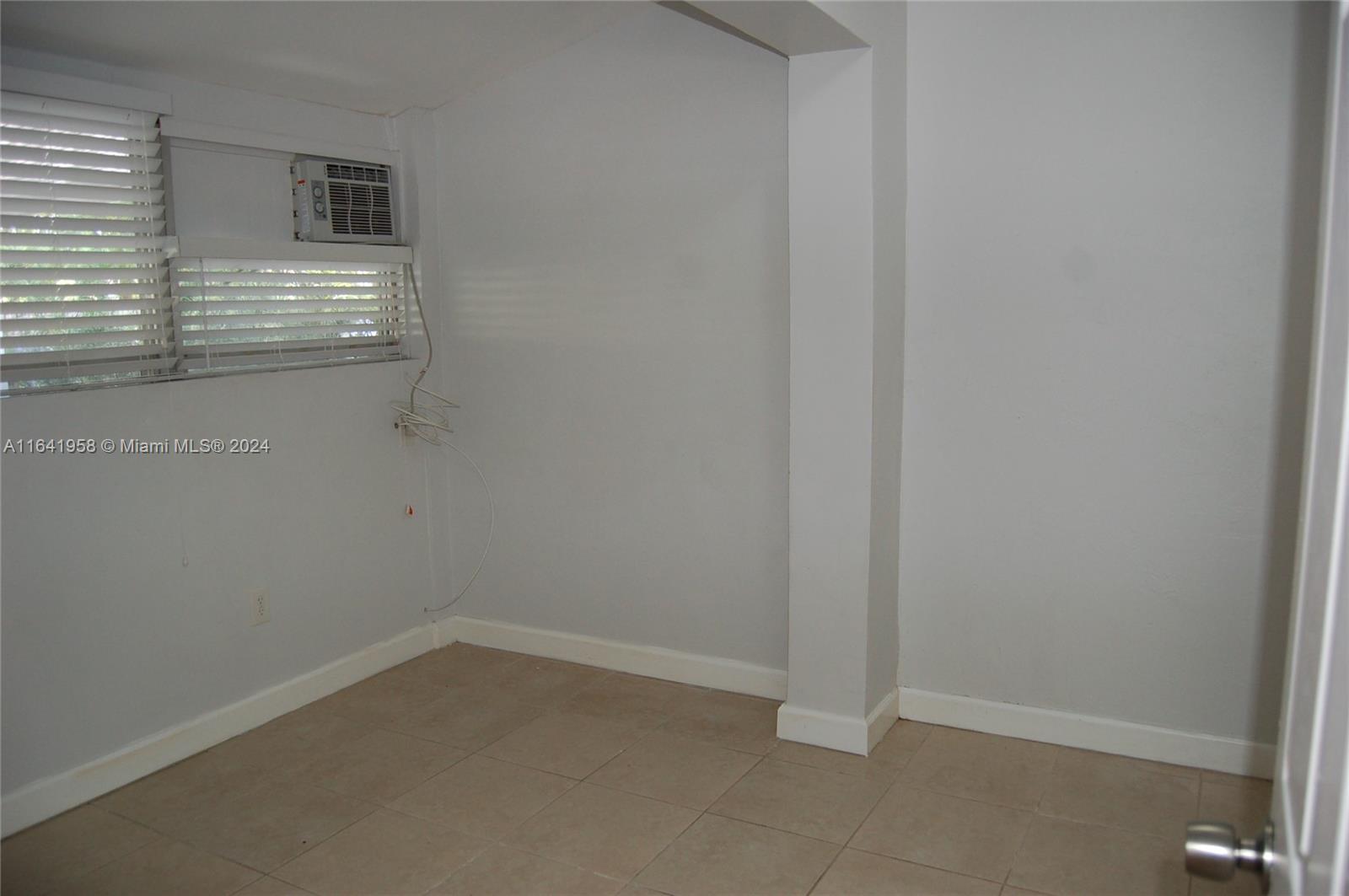 2481 Southwest 11th Street, Unit 2481 Miami, FL 33135 - Photo 5 of 9 a room that has a window in it