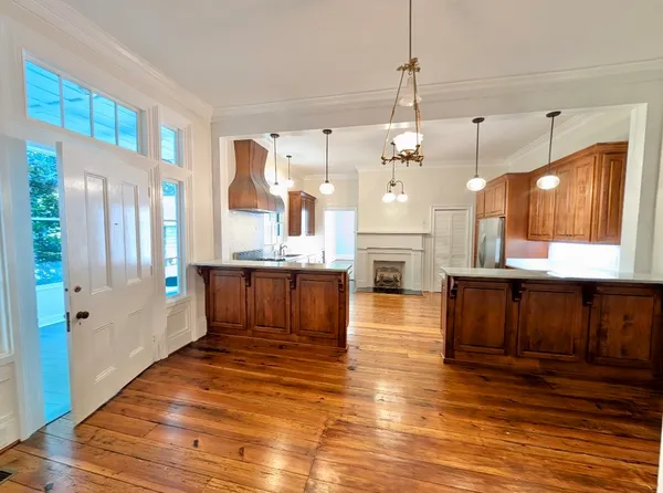 a large kitchen with a counter space a sink appliances and cabinets