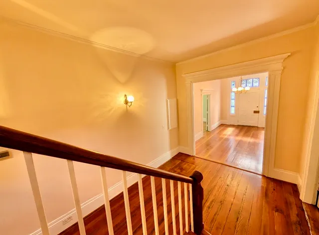 a view of a hallway with wooden floor