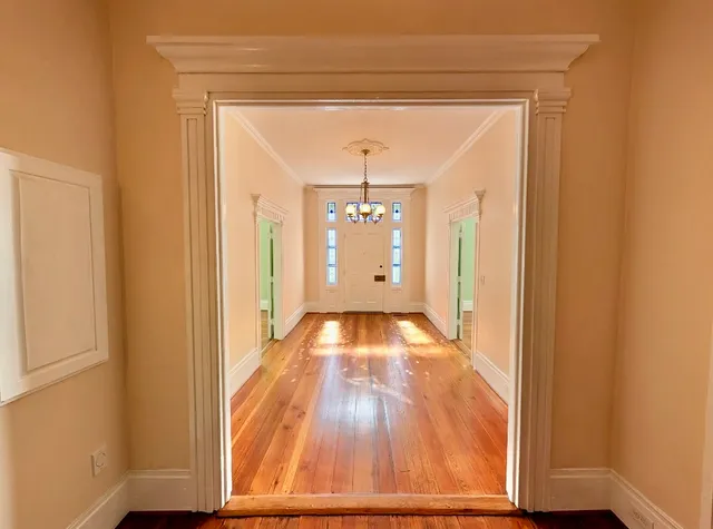 a view of a room with wooden floor and a window
