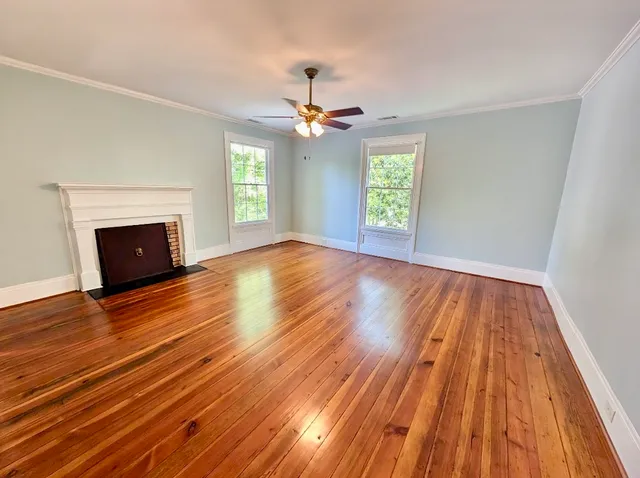 wooden floor in an empty room with a fireplace