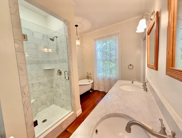 a en suite spacious bathroom with a granite countertop tub shower and a sink