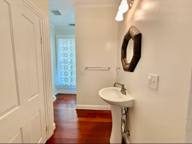 a bathroom with a sink a mirror and a light fixture