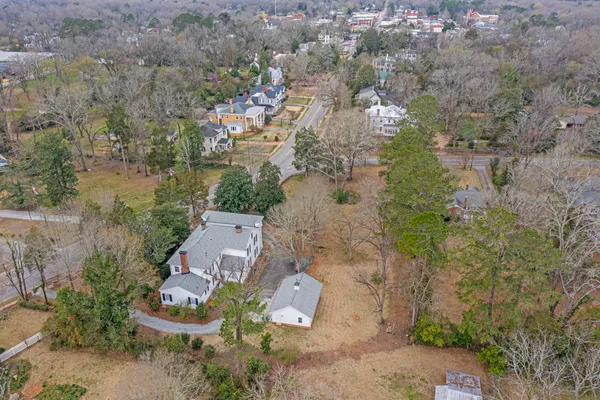 an aerial view of a house with a yard and lake view
