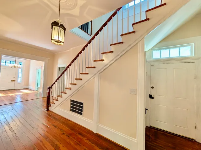 a view of entryway and hall with wooden floor