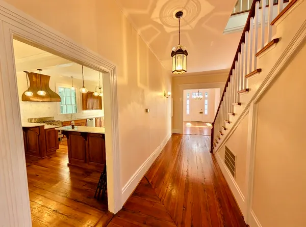 a view of a hallway view with wooden floor and staircase