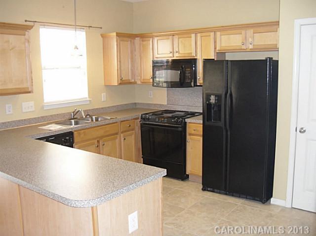 8236 Townley Road Huntersville, NC 28078 - Photo 6 of 10 a kitchen with stainless steel appliances granite countertop a sink stove and refrigerator