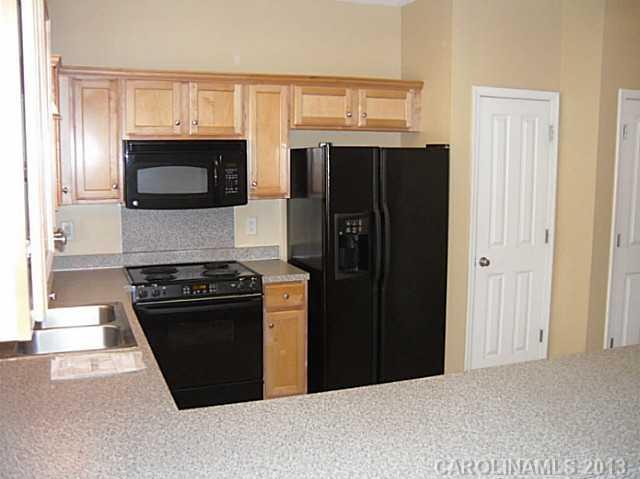 8236 Townley Road Huntersville, NC 28078 - Photo 7 of 10 a kitchen with stainless steel appliances granite countertop a refrigerator stove and microwave