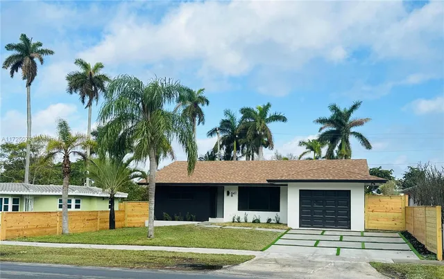 a house with palm tree in front of it