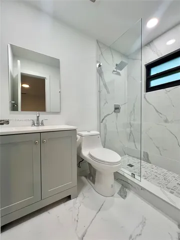 a bathroom with a toilet sink and shower