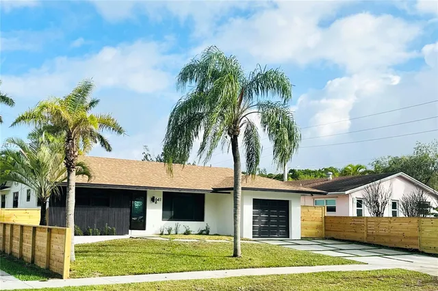 a front view of house with yard and outdoor seating