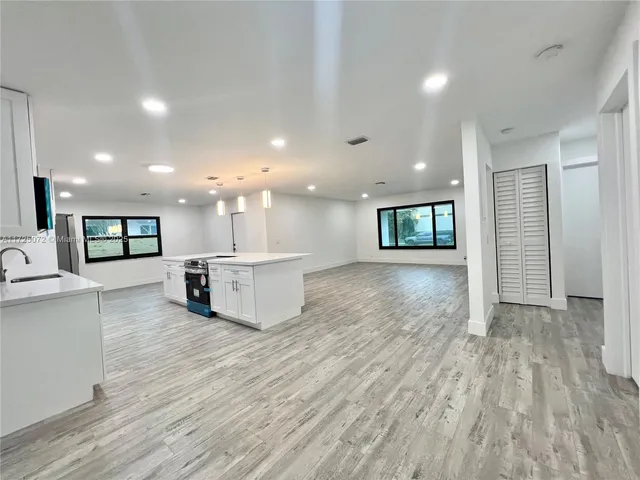 a view of kitchen with a sink and a large window