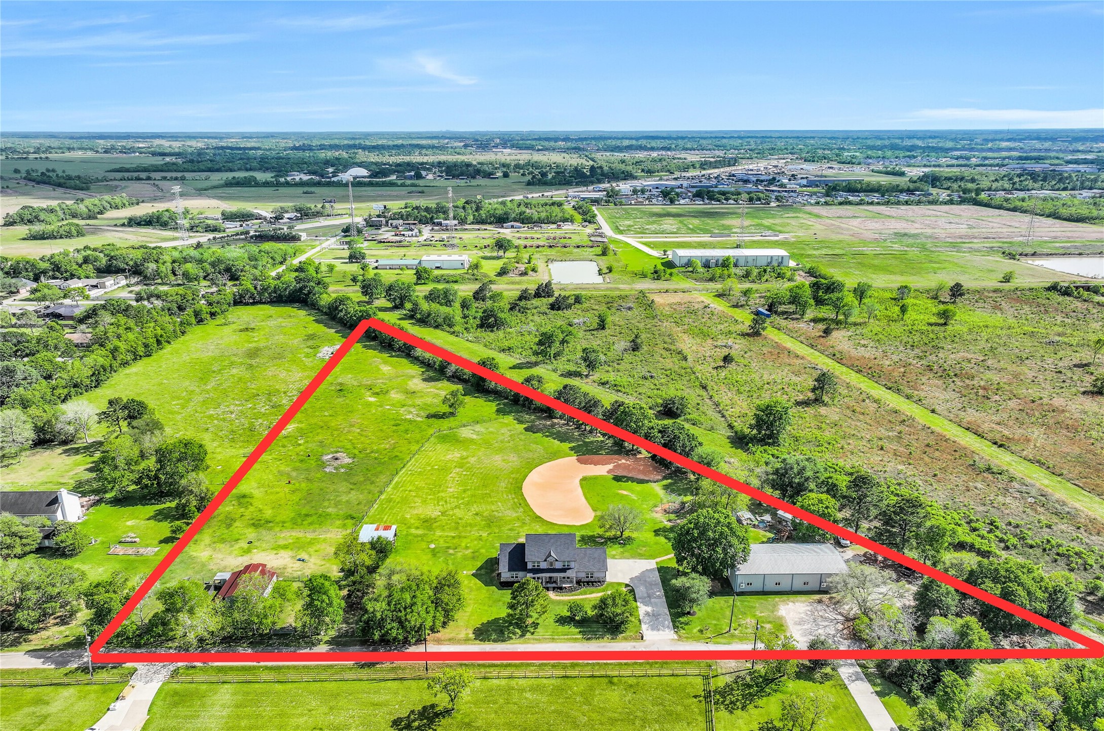 Welcome to 1404 Hollier Road, where you'll find 6+ acres of property, complete with a 2601 SF home, a 40'x80' conditioned metal building, a baseball diamond, cowboy pool, 7 stall barn, & open pasture. With no HOA restrictions, the possibilities for customization and use are wide open!