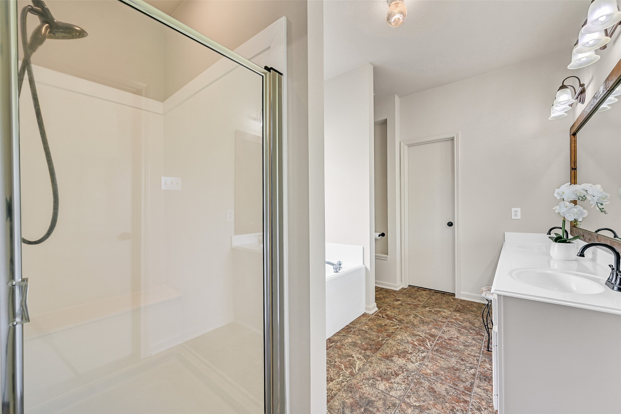 1404 Hollier Road Friendswood, TX 77546 - Photo 25 of 46 A separate glass-enclosed shower and extended vanity complete the primary bath, offering a practical layout with plenty of space. Clean finishes and a well-balanced design make this area easy to navigate and maintain.
