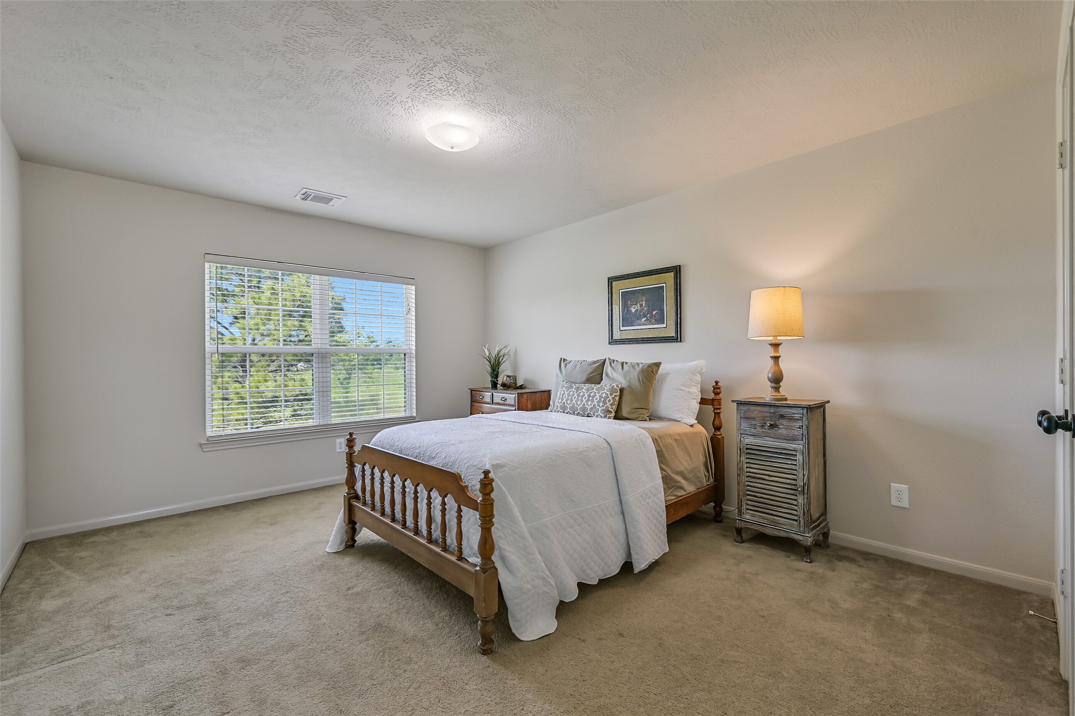 1404 Hollier Road Friendswood, TX 77546 - Photo 27 of 46 Another secondary bedroom features a spacious layout with a large window overlooking the property. The room offers flexibility for guests, family, or additional workspace.