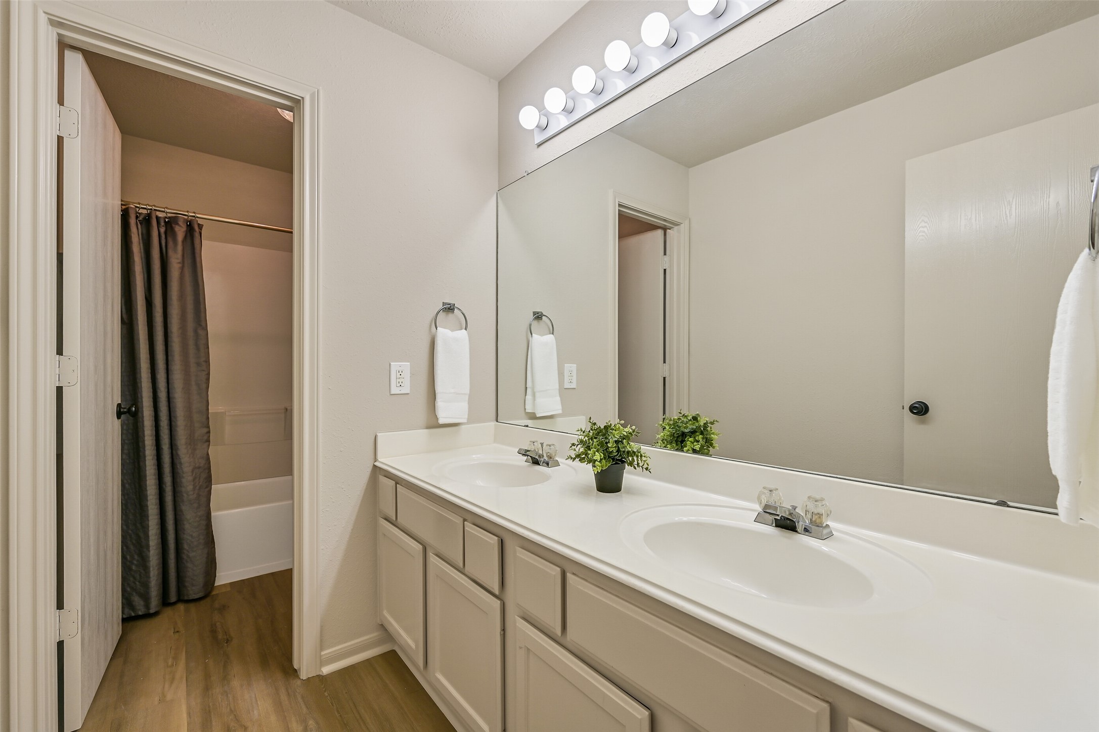 1404 Hollier Road Friendswood, TX 77546 - Photo 28 of 46 The upstairs bathroom includes a long double-sink vanity with ample counter space and storage below. A separate tub and shower area allows for easy use while keeping the vanity space open.