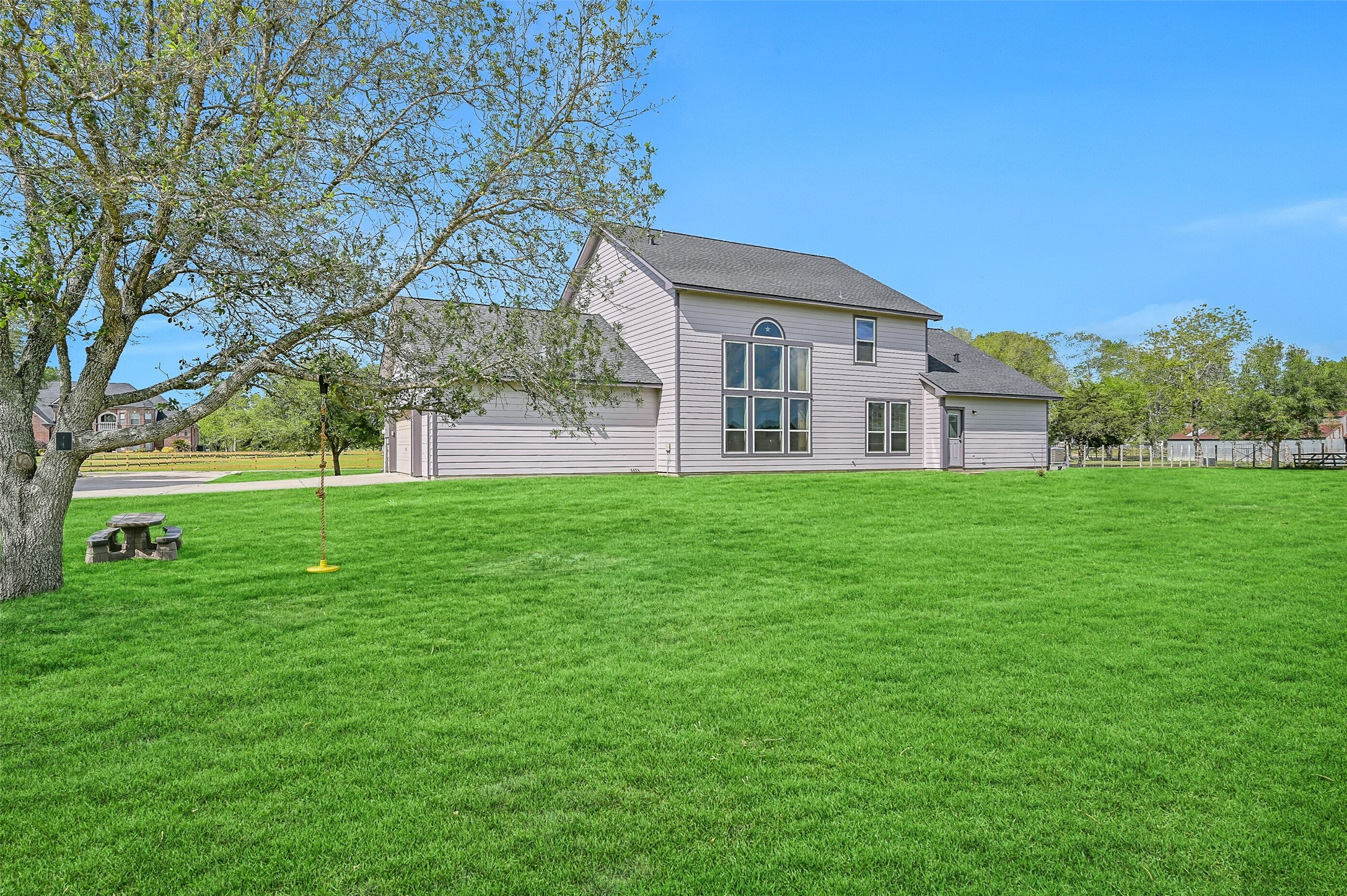 1404 Hollier Road Friendswood, TX 77546 - Photo 30 of 46 The expansive backyard showcases the scale of this 6+ acre property, with wide open green space, mature trees, and plenty of room for recreation, animals, or future improvements.