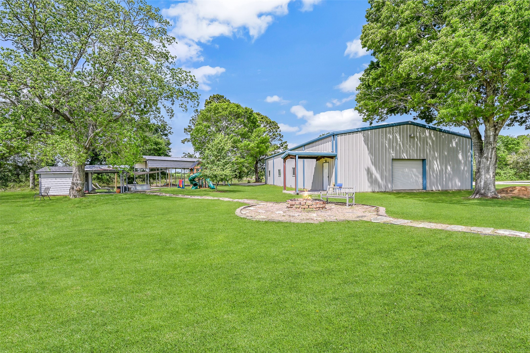 1404 Hollier Road Friendswood, TX 77546 - Photo 32 of 46 The 40’x80’ insulated and conditioned metal building offers exceptional versatility, currently set up as a baseball training facility. With bay doors on both ends and ample parking behind, this space adapts easily to a variety of uses.