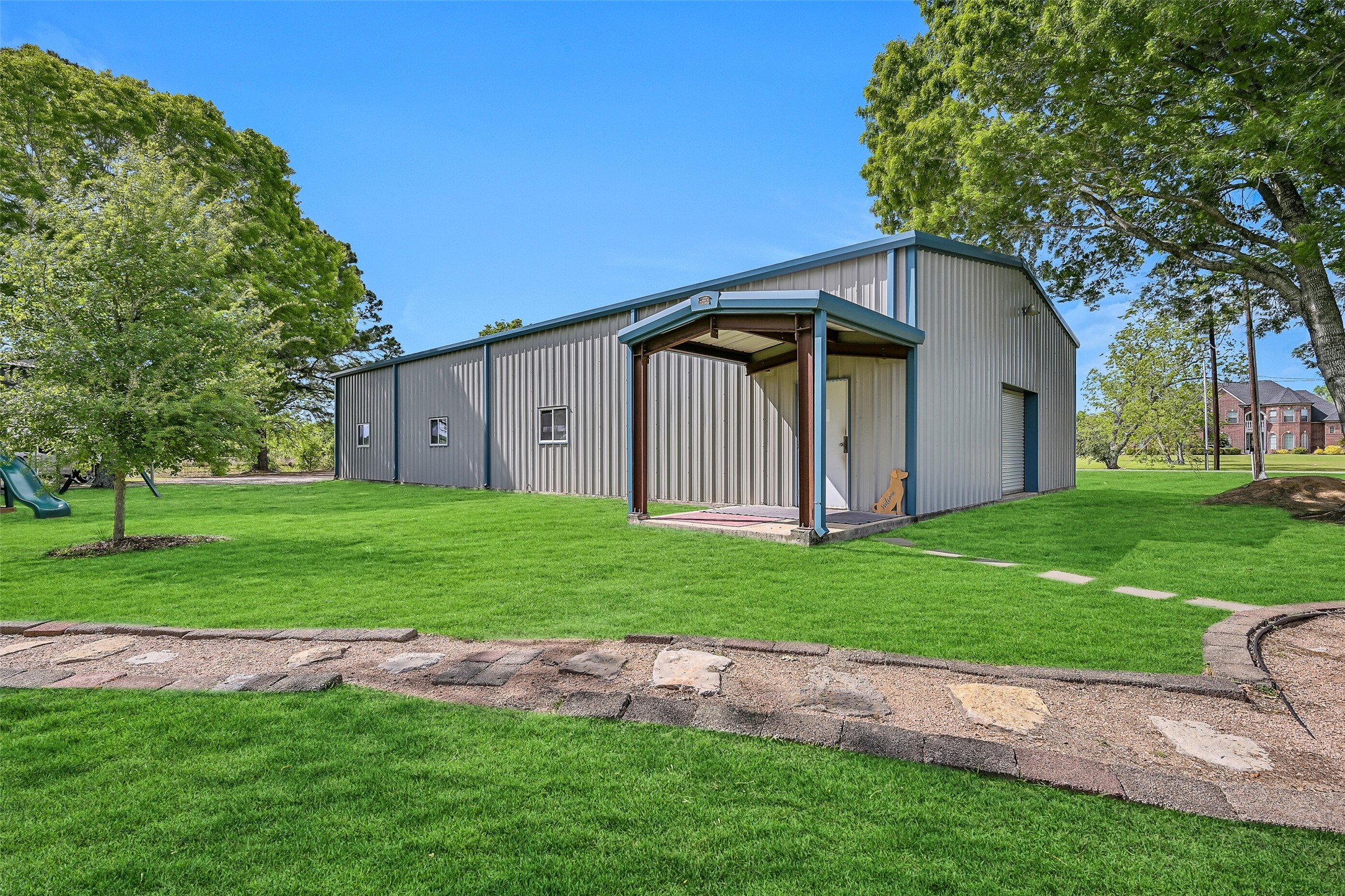 1404 Hollier Road Friendswood, TX 77546 - Photo 33 of 46 The 40’x80’ insulated and conditioned metal building offers exceptional versatility, currently set up as a baseball training facility. With bay doors on both ends and ample parking behind, this space adapts easily to a variety of uses.