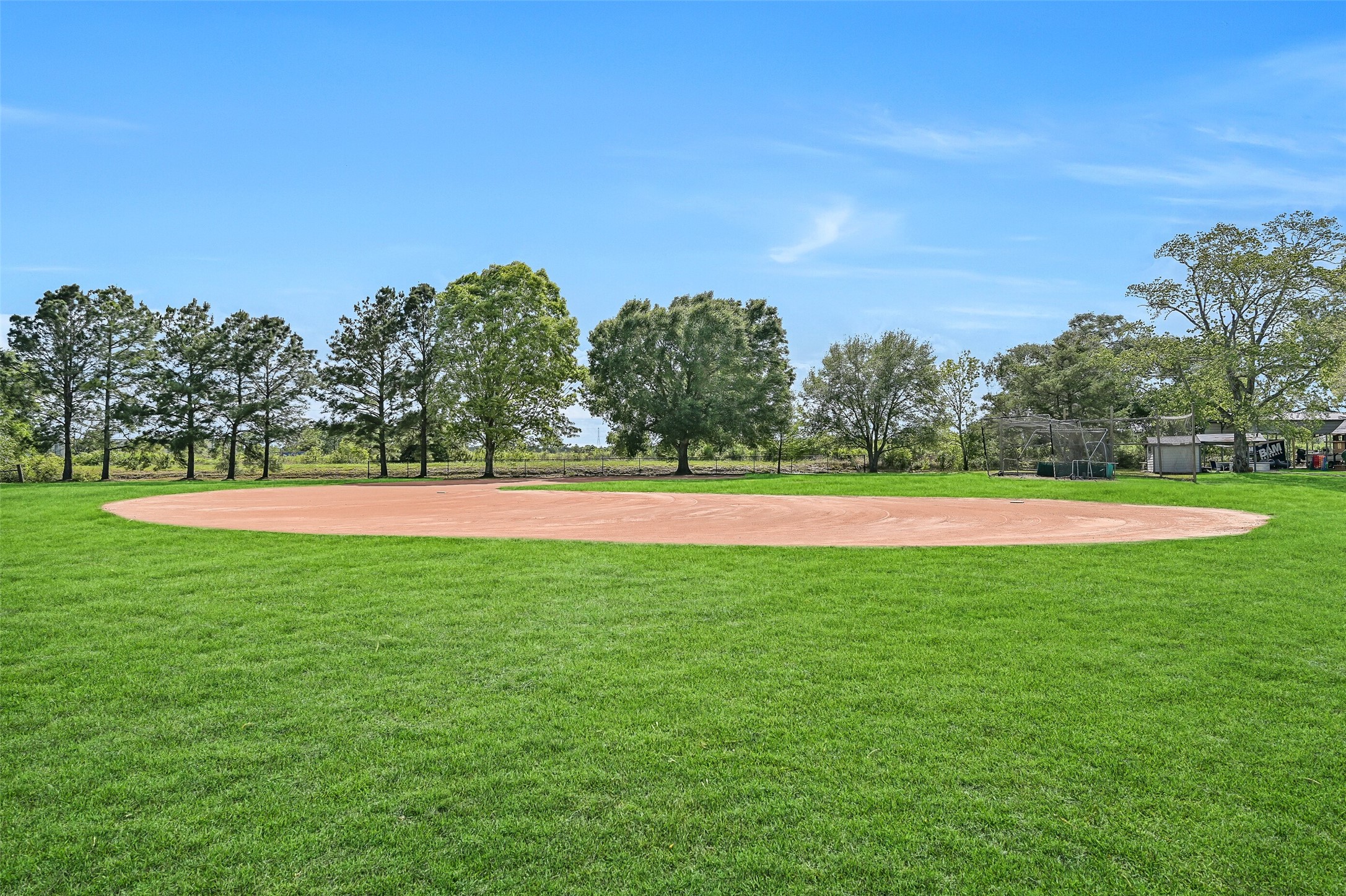 1404 Hollier Road Friendswood, TX 77546 - Photo 41 of 46 A full baseball field with its own sprinkler system adds a unique feature rarely found on residential properties. The open layout and maintained grounds make it ready for practice or play.
