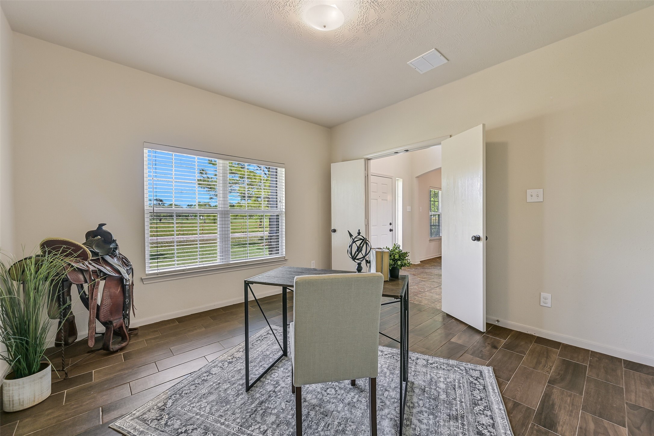 1404 Hollier Road Friendswood, TX 77546 - Photo 10 of 46 Another view of the study highlights its flexibility and natural light, with plenty of room for a full desk setup. Positioned near the front of the home, this space can easily serve as an office, hobby room, or additional living area.