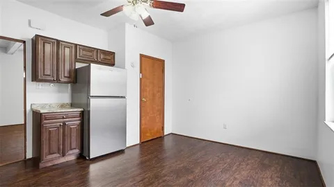 a kitchen with stainless steel appliances a refrigerator and a chandelier