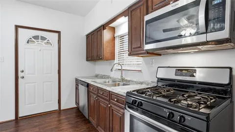 a kitchen with stainless steel appliances granite countertop a stove and a microwave