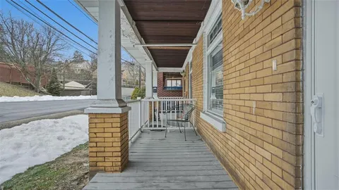 a view of a brick house with wooden floor and iron stairs