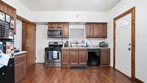 a kitchen with stainless steel appliances granite countertop a stove a sink and a refrigerator