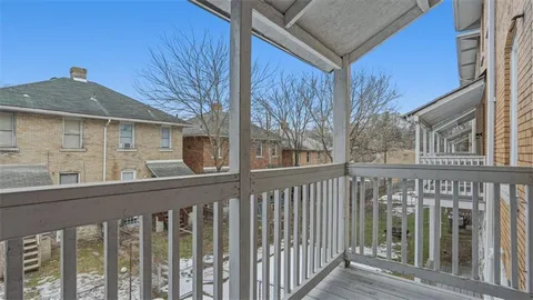 a view of a brick house with large windows