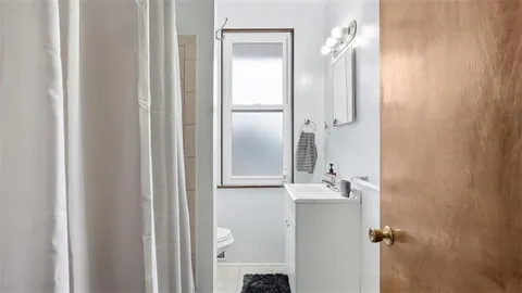 a bathroom with a glass shower door