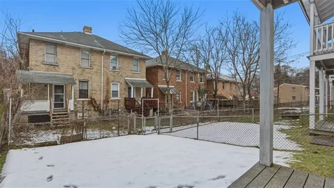 a view of a house with a backyard