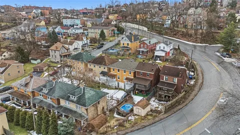 an aerial view of a chairs and table on the balcony