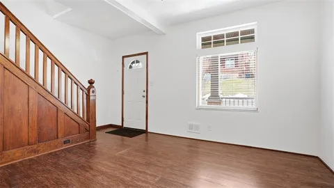 an entryway with stairs and a window